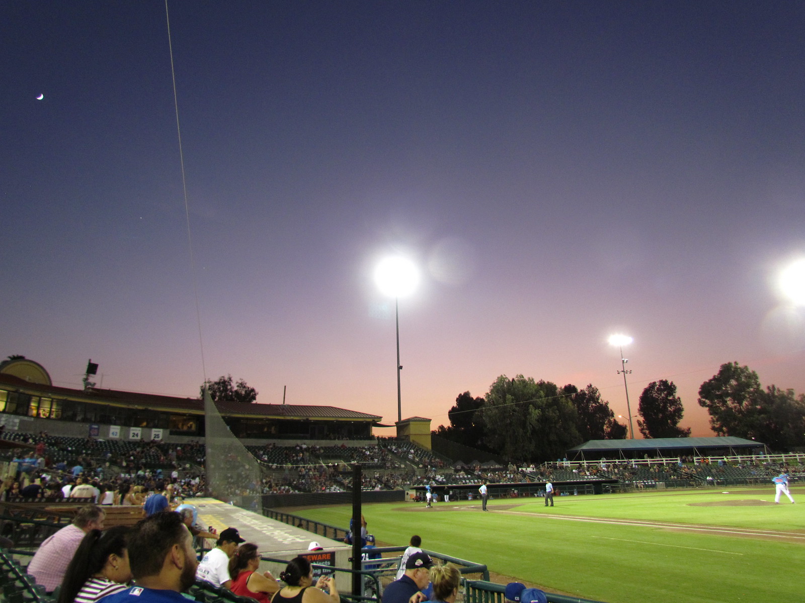 Night time view of baseball being played in the stadium