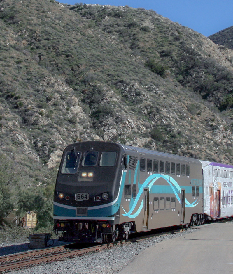 Metrolink train next to a hillside