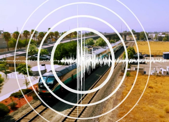 seismograph graphic overlaid on a picture of a train