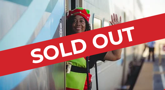 A picture of the Metrolink Holiday Express Trains at a station with one of Santa's Helpers waving from inside with a red diagonal banner saying SOLD OUT overlayed on image.