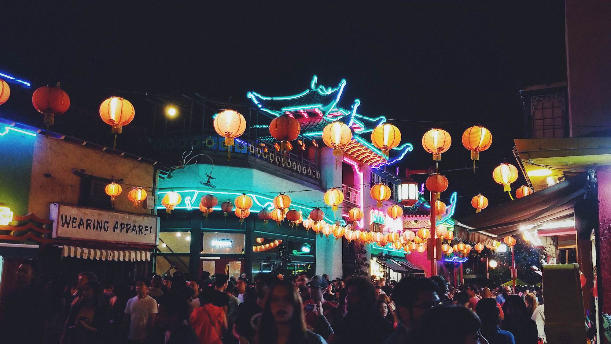 Chinatown at night lit with neon lights and paper lanterns