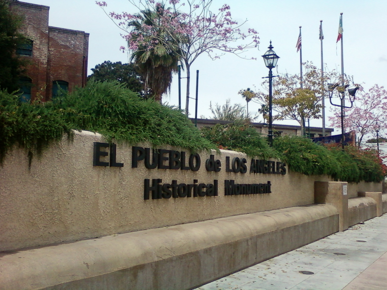 El Pueblo de Los Angeles Historical Monument entrance sign on wall.