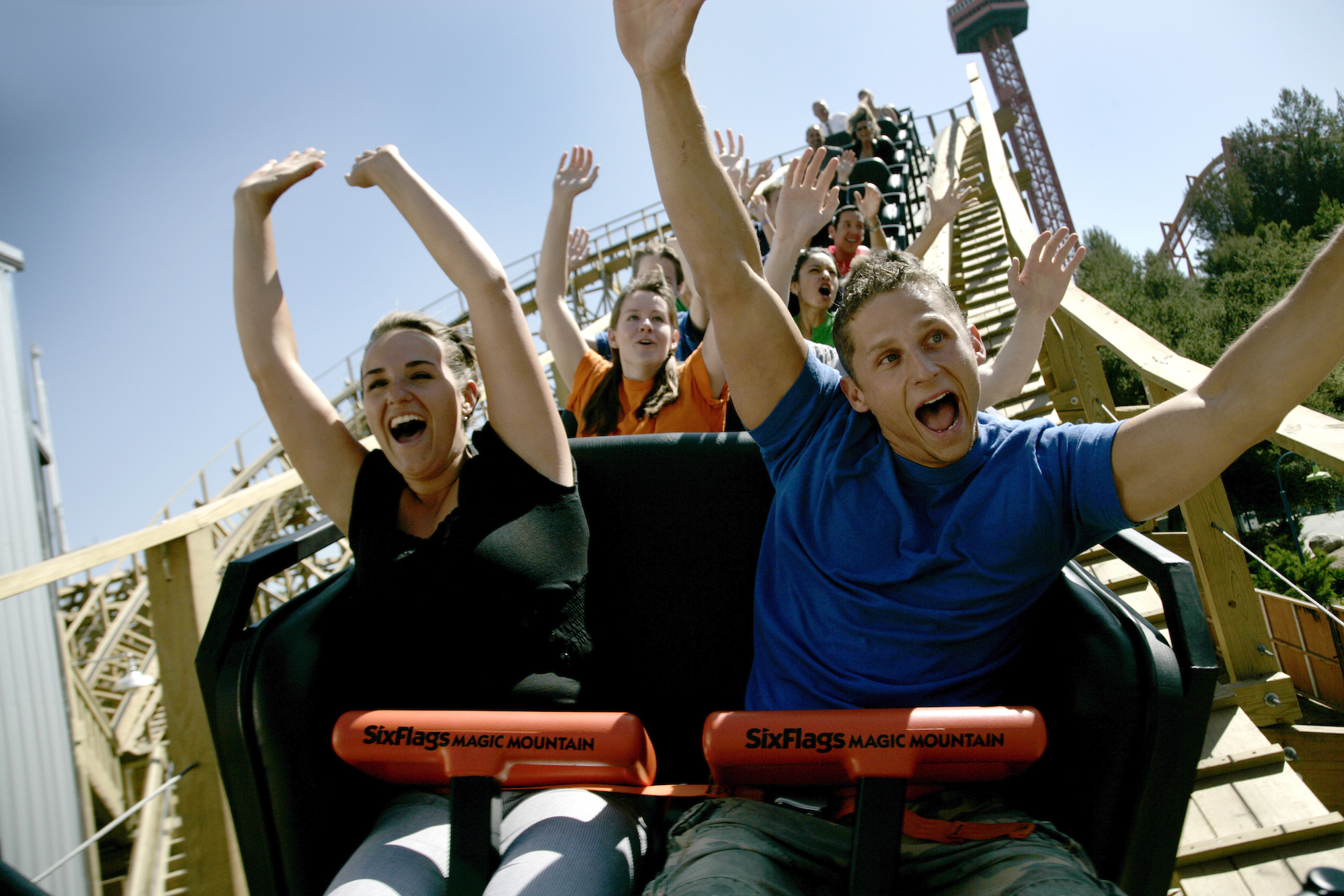 Park visitors with their arms raised on Apocalypse at Six Flags Magic Mountain