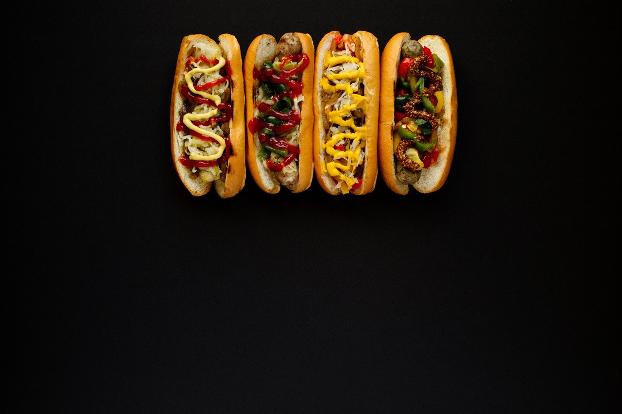Four hotdogs with assorted toppings