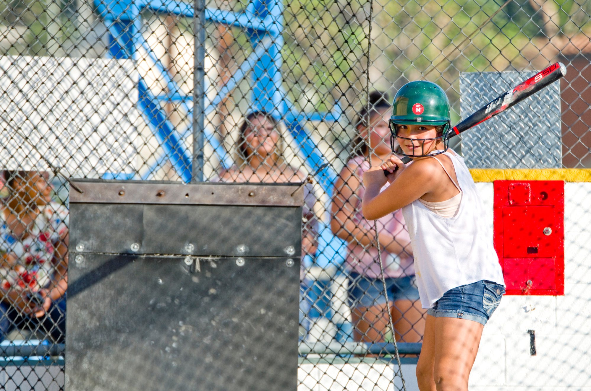 Young girl at the batting cages at the Fiesta Village Family Fun Park.