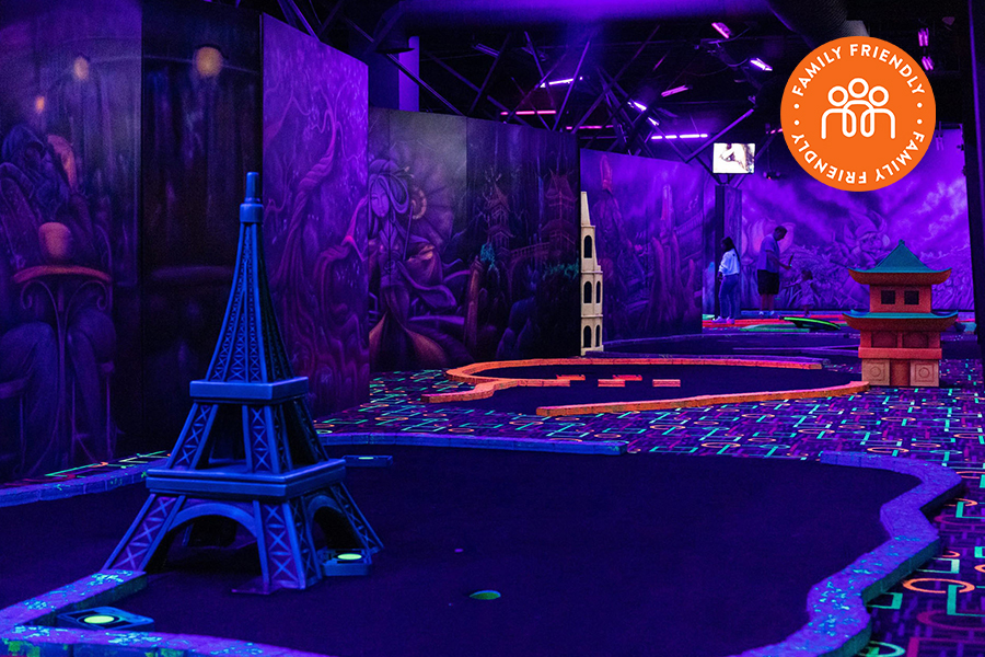 Glow in the dark miniature golf at GLO Mini Golf.  Image stamped with a Family Friendly badge.