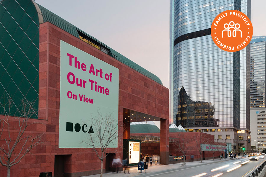 Outside view of the MOCA with the sign outside reading "The Art of Our Time on View". Image stamped with Family Friendly badge