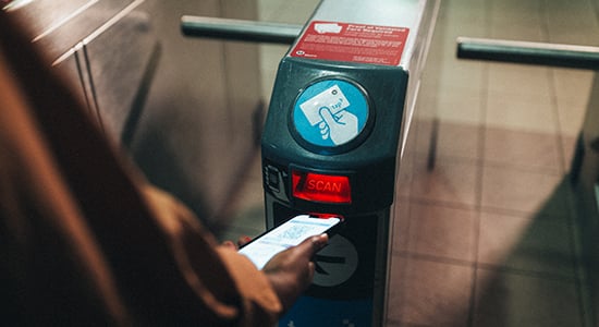 Metrolink customer tapping at Metro gate.